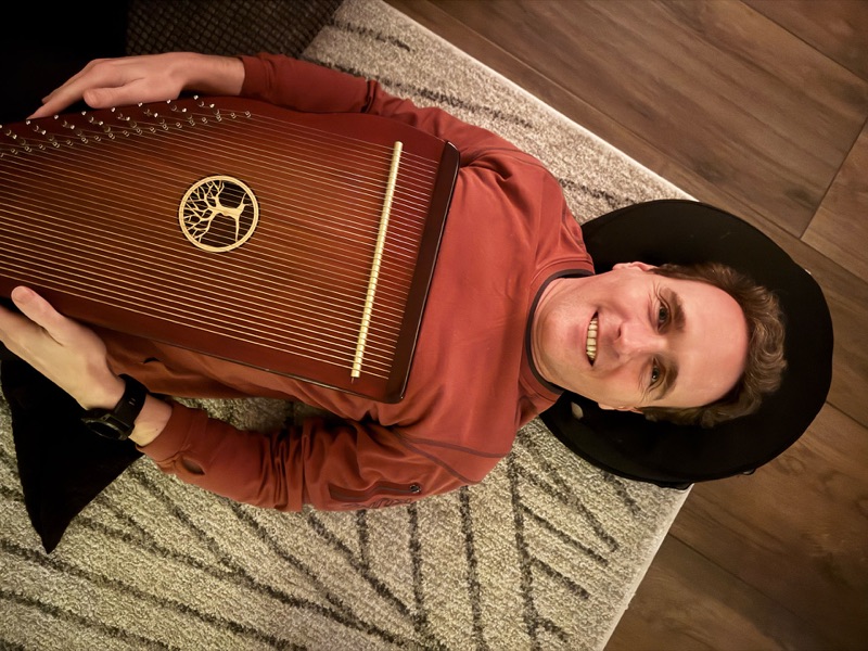 Daniel Branco with a lap harp